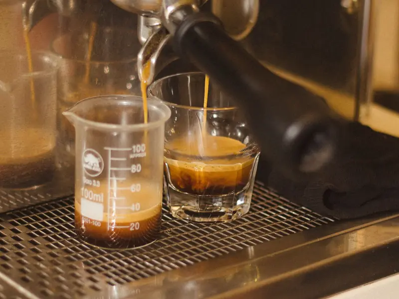 Espresso pouring into glasses from a machine
